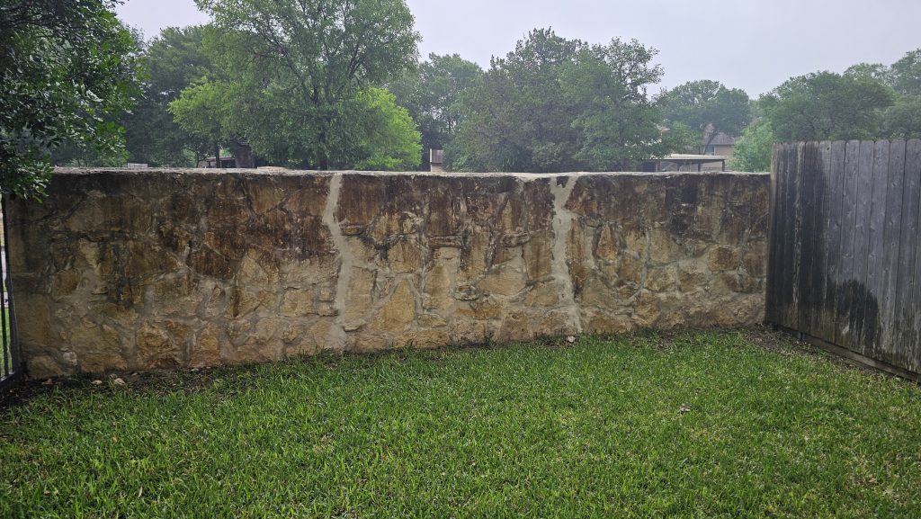 Stone Wall Before Soft Washing in San Antonio